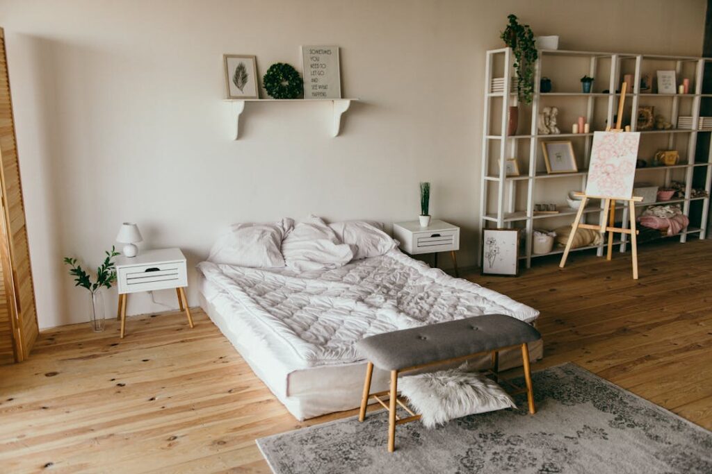 A hardwood bedroom with a rug