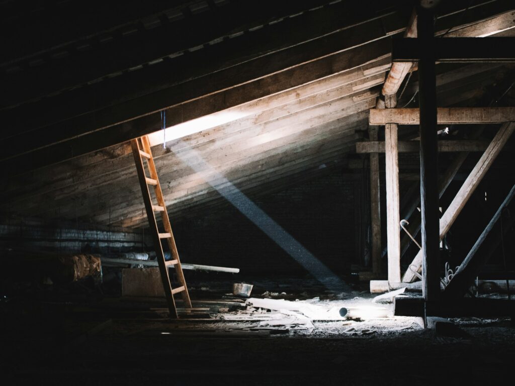 An attic with a ladder and rays of light