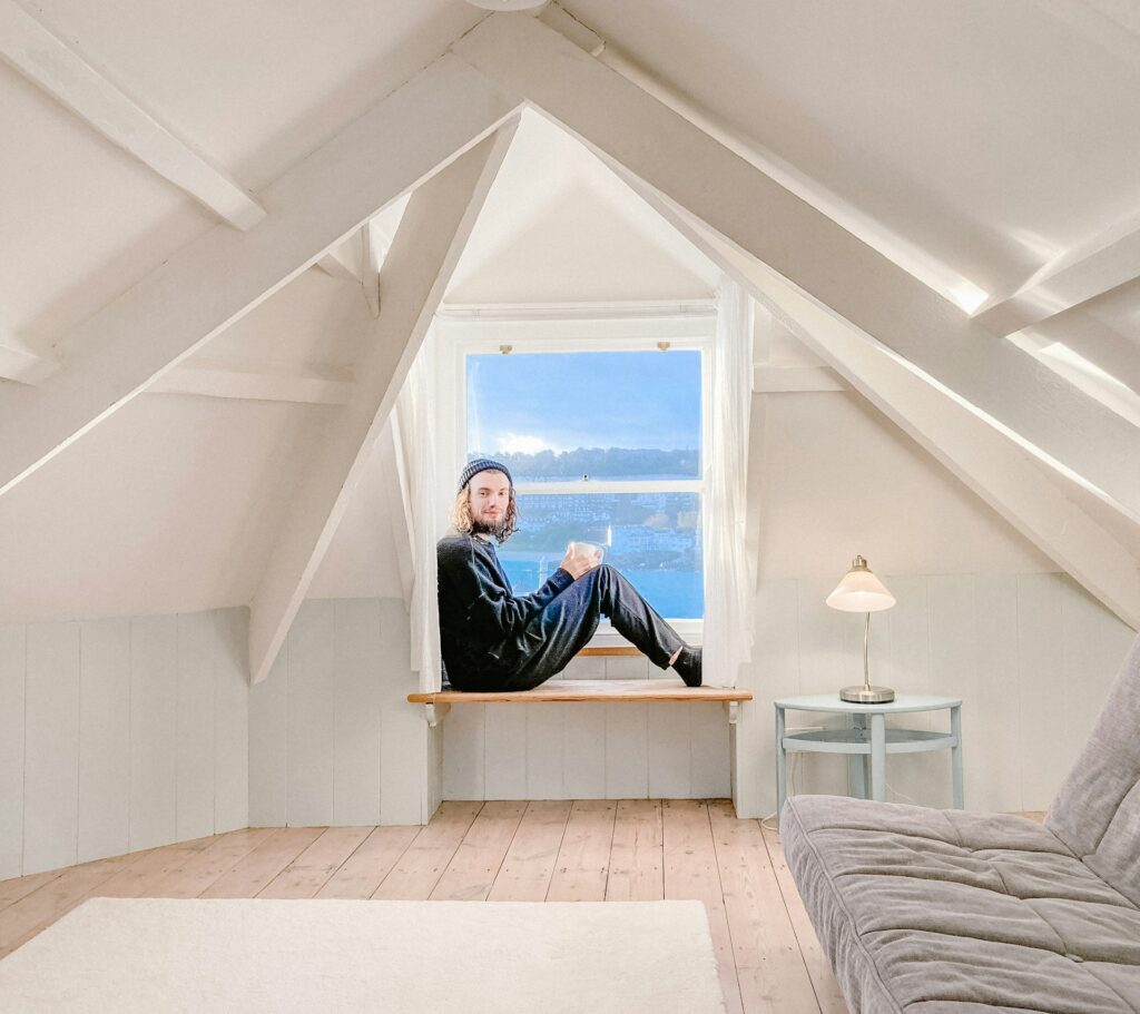 A man sitting on the edge of a clean attic