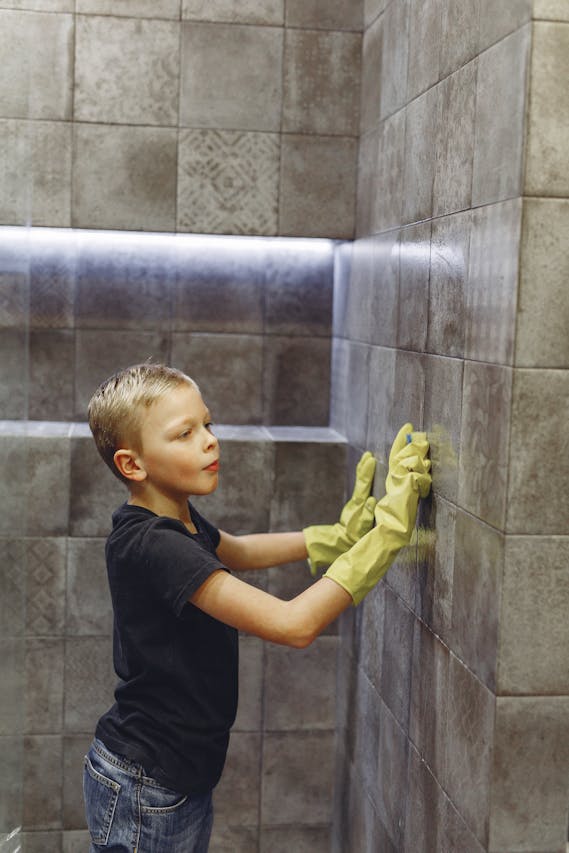 A boy cleaning a wall